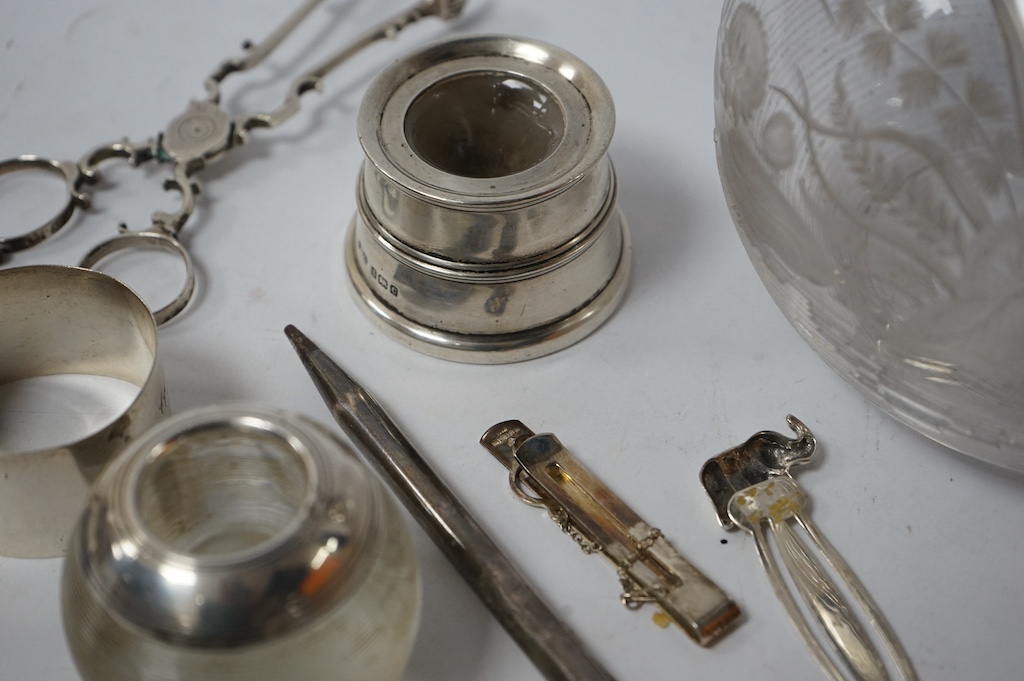 A pair of mid 18th century silver sugar nips, by Alexander Osborne, London, circa 1765, 11.6cm, together with a silver mounted glass match strike, a silver mounted inkwell, a silver napkin ring, a cased silver medallion